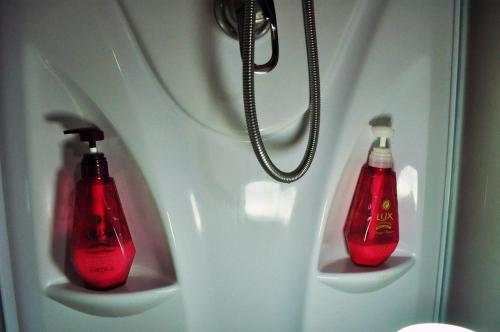 two bottles of coke are hanging on a wall at Guest house HiDE in Lake Toya