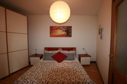 a bedroom with a bed with two tables and a lamp at Casa Milla in Tremezzo