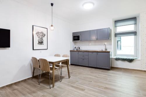 a kitchen and dining room with a table and chairs at NY7 Apartment in downtown in Budapest