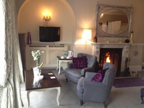a living room with two chairs and a fireplace at The Castle House in Richmond
