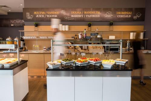 a kitchen filled with lots of fruits and vegetables at Novotel Vilnius Centre in Vilnius