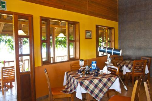a dining room with two tables and a camera at Finca Hamburgo La Ruta del Cafe in Tapachula