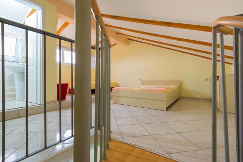 a room with a bed and a staircase at Vila Vukotić in Petrovac na Moru