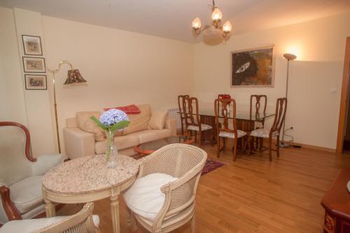 a living room with a table with a vase of flowers on it at Beatiful holiday flat in Galicia with sea views and next to the "Camino de Santiago" in Estorde