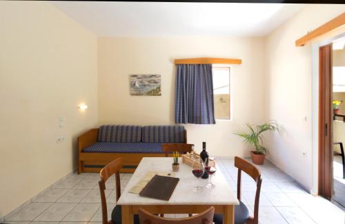a living room with a table and a couch at Ariadne Beach in Plataniás