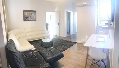 a living room with a couch and a table at Munich Aparthotel in Munich