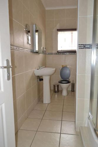 a bathroom with a sink and a toilet at City Stay in Maseru