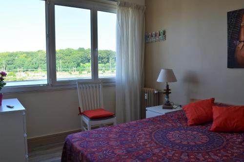 a bedroom with a bed and a large window at L'âme Nomade - Bayonne Centre in Bayonne