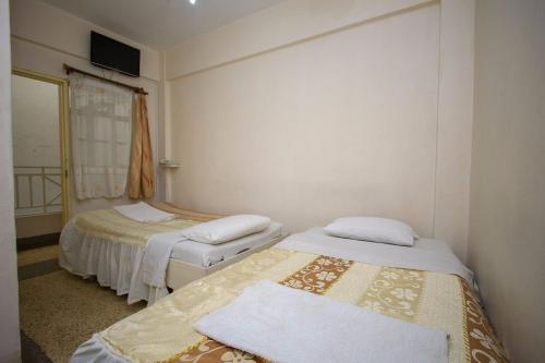 Postel nebo postele na pokoji v ubytování Rabi Hotel