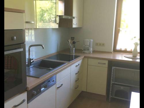 cocina con fregadero y fogones en Ferienwohnung Bellevue 2, en Staufenberg