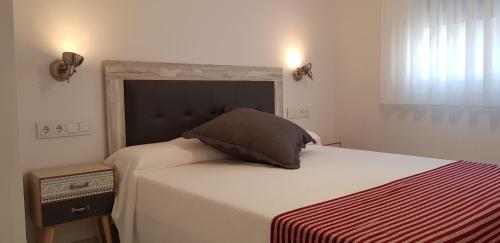 a bedroom with a bed with a pillow on it at Apartamentos Miradores del Isasa in Herce
