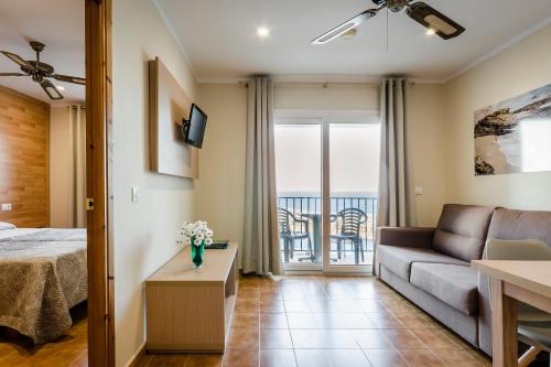 a living room with a couch and a table at Apartamentos Blancala in Cala Blanca