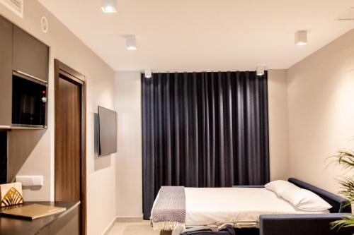 a bedroom with a bed and a black curtain at Ramirez Flats Valencia in Valencia