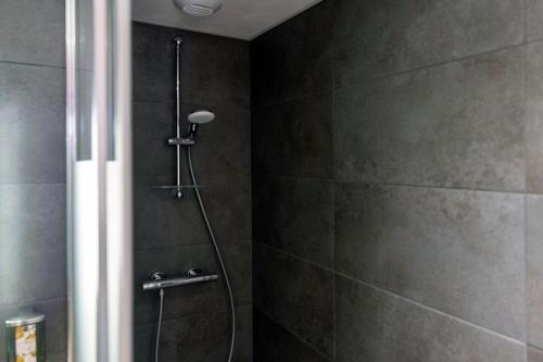 a bathroom with a shower with a glass door at Hotel KLE, BW Signature Collection in Kaysersberg