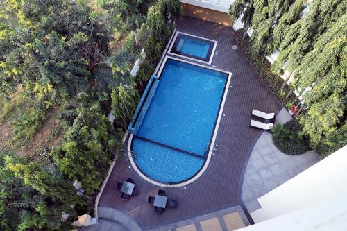 an overhead view of a swimming pool with two chairs at Patria Suites in Rajkot