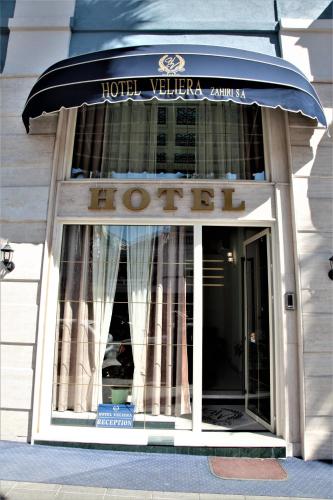 a hotel building with a sign that reads houston at Hotel Veliera in Durrës