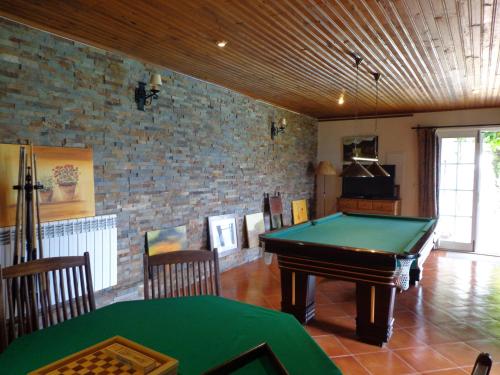 a room with a pool table and a brick wall at Casa De Canilhas in Mesão Frio