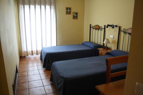 Ένα ή περισσότερα κρεβάτια σε δωμάτιο στο Hostal La Balquina