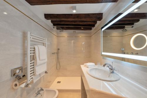 a bathroom with a sink and a mirror at Hotel Giorgione in Venice