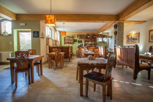 a dining room with wooden tables and chairs at Willa Ryś in Zakopane