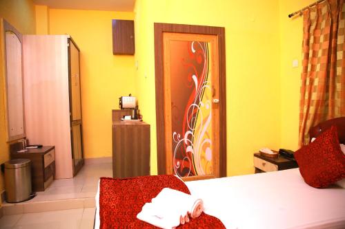 a room with a door with a flower painted on it at Babul Hotel in Kolkata