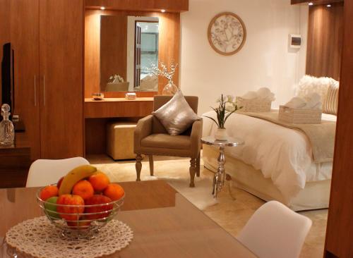 a bedroom with a bed and a bowl of fruit on a table at Keret Accommodation in Bellville