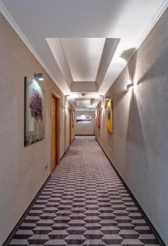 a hallway with a tile floor in a building at Porto Palace Hotel Thessaloniki in Thessaloniki