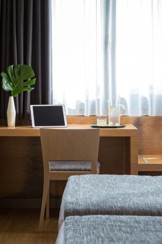 a desk with a laptop computer on top of it at Porto Palace Hotel Thessaloniki in Thessaloniki