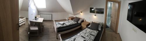 a living room with a couch and a table at Sobe-Rooms Kvatric in Zagreb