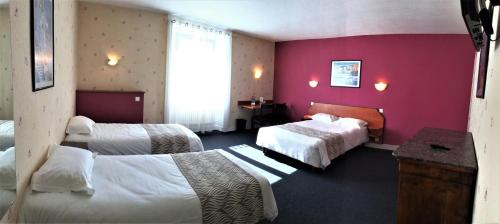 a hotel room with two beds and a window at Nouvel Hotel in Lons-le-Saunier
