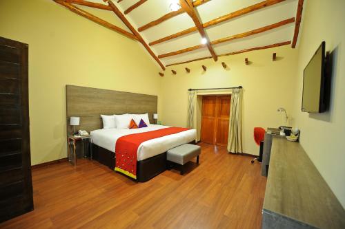 a hotel room with a bed and a television at Union Hotel Cusco in Cusco