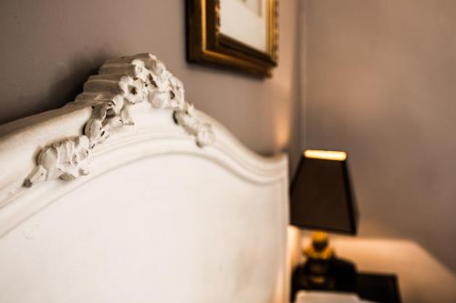 a close up of the top of a white bed at Hotel Du Midi in Visan