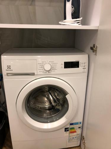 a white washer and dryer in a cabinet at Family & Business Sauna Apartments No1 Leśny nad Zalewem Cedzyna Unikat - 3 Bedroom with Private Sauna, Bath with Hydromassage, Terrace, Garage, Catering Options in Kielce