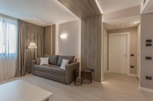 a living room with a couch and a window at Hotel Victoria in Vicenza