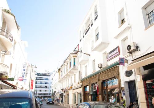 a street with buildings and cars on a city street at Appartements Rabat Balima Harcourt in Rabat