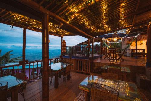 a restaurant with tables and chairs on a deck at Monte Mágico in Támesis