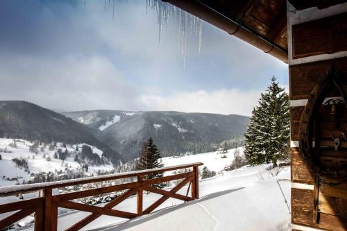 a view of a snow covered mountain from a cabin at Horský Ranč in Pec pod Sněžkou
