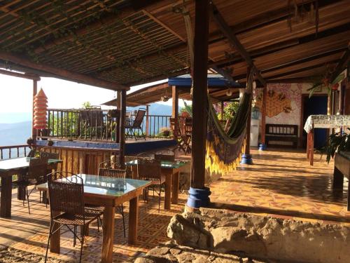 a patio with tables and chairs and a hammock at Monte Mágico in Támesis
