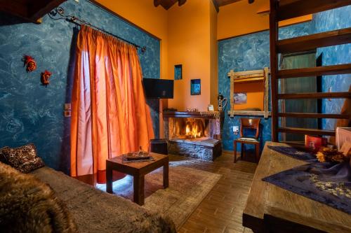 a living room with a couch and a fire place at Ξενώνας Οντάς και Spa in Arachova