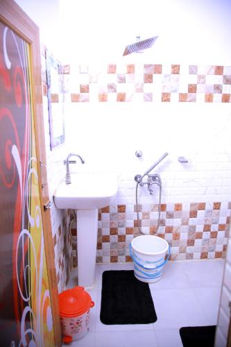 a bathroom with a sink and a toilet at Babul Hotel in Kolkata
