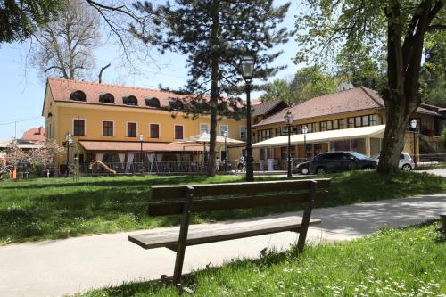 a park bench in front of a house at Hotel Lavica in Samobor