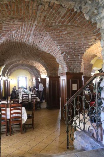 a restaurant with a brick ceiling and tables and chairs at Hotel Lavica in Samobor