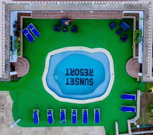 an overhead view of a swimming pool with blue chairs at Beyond Sunset Resort & Villas in Treasure Beach