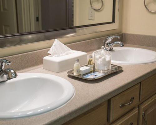 a bathroom counter with two sinks and a mirror at Lodge at Kingsbury Crossing in Stateline