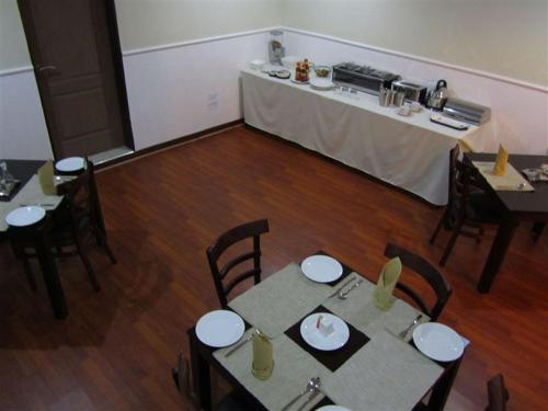 a room with tables and chairs in a room with a tableablish at Road Stay in Maseru