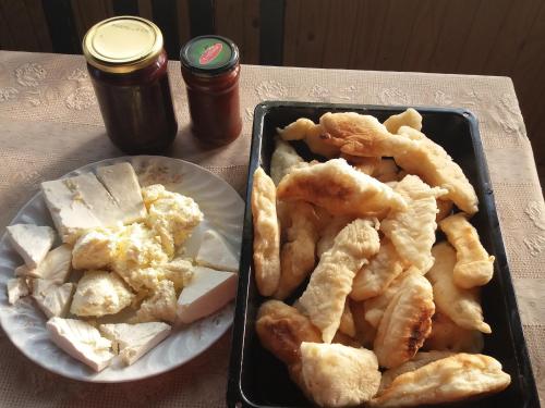 a table with a tray of food and a plate of food at Holiday Home Vila Milka in Kremna