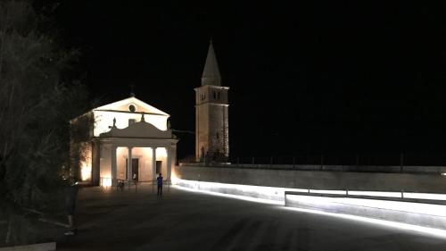 a person standing in front of a building at night at Cà dell'Angelo - Caorle in Caorle