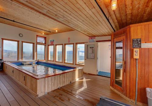 
a large room with wooden floors and a wooden deck at Land's End Resort in Homer
