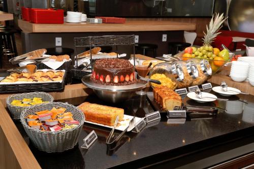 a buffet with many different types of bread and cakes at ibis Natal in Natal