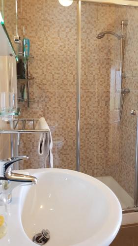 uma casa de banho com um lavatório e um chuveiro em Seaview Apt in Buncrana with balcony em Buncrana
